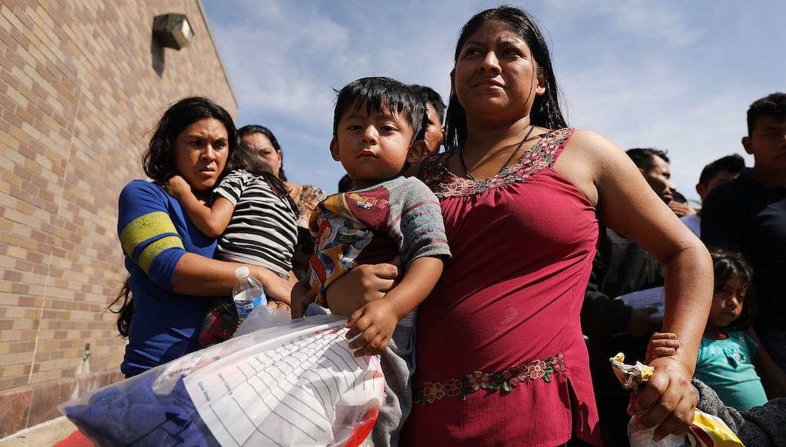 MCALLEN, TX - JUNE 23: Dozens of women, men and their children, many fleeing poverty and violence in Honduras, Guatamala and El Salvador, arrive at a bus station following release from Customs and Border Protection on June 23, 2018 in McAllen, Texas. (Photo by Spencer Platt/Getty Images)