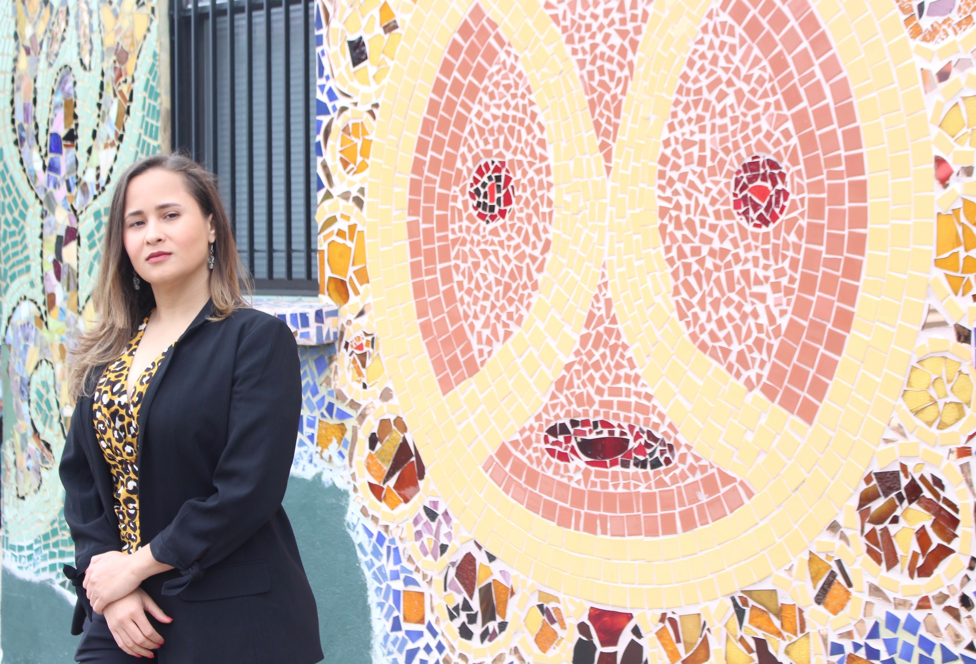 Executive director Siria Rivera stands in front of mural that covers the outside of Providence Center in Fairhill, Philadelphia. Photo: Jensen Toussaint/AL DÍA News. 