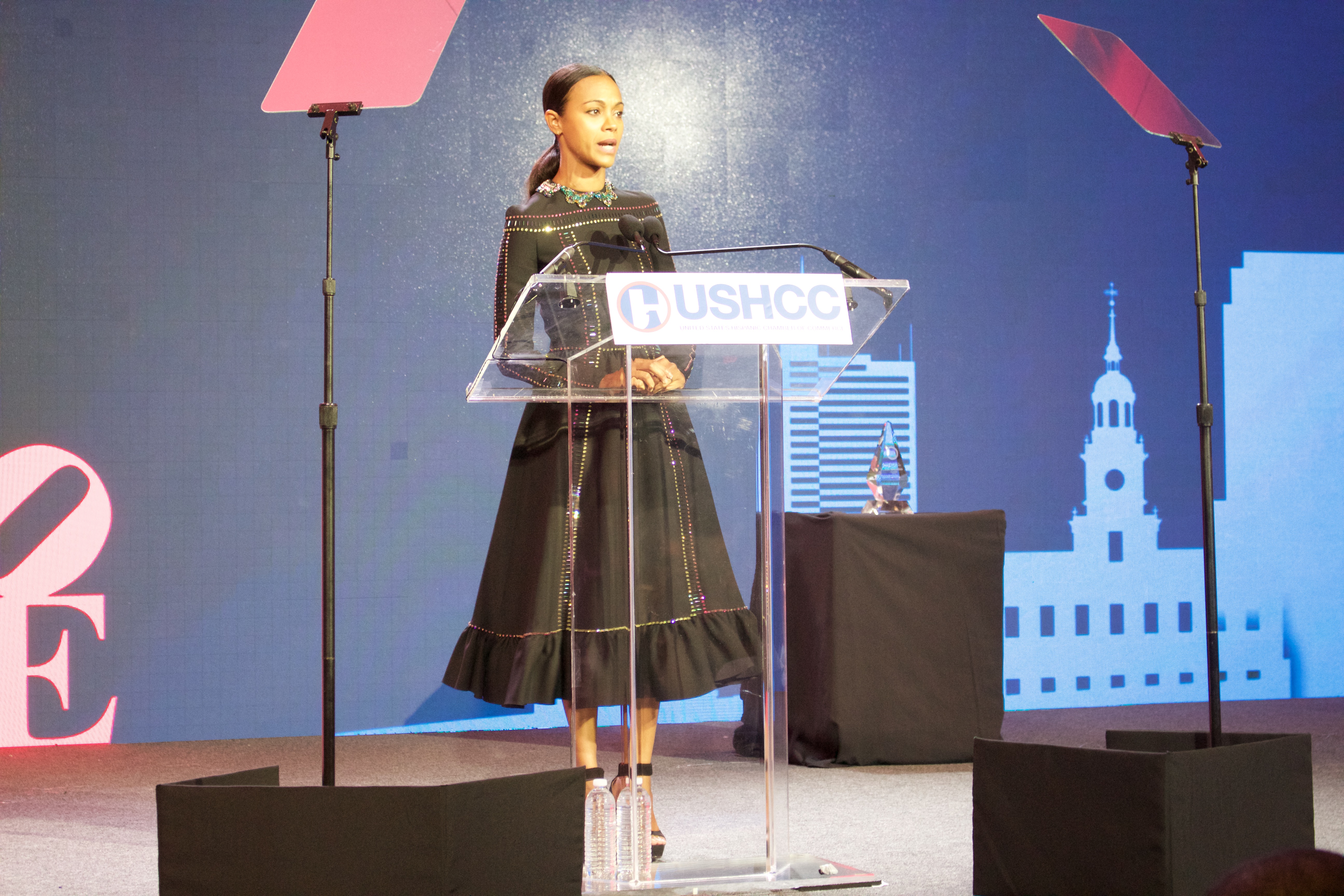 Zoe Saldana giving a speech at the USHCC National Convention about her journey towards starting her own business, BESE.