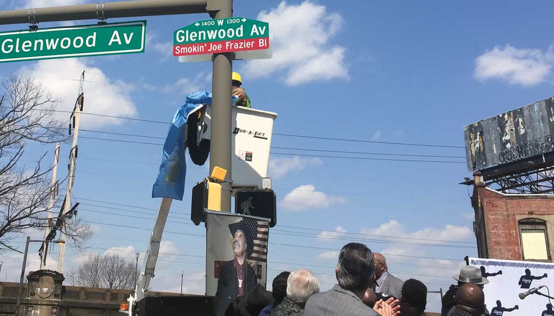 Taking the wraps off of street sign honoring legendary boxing champion Joe Frazier. Photo LBW