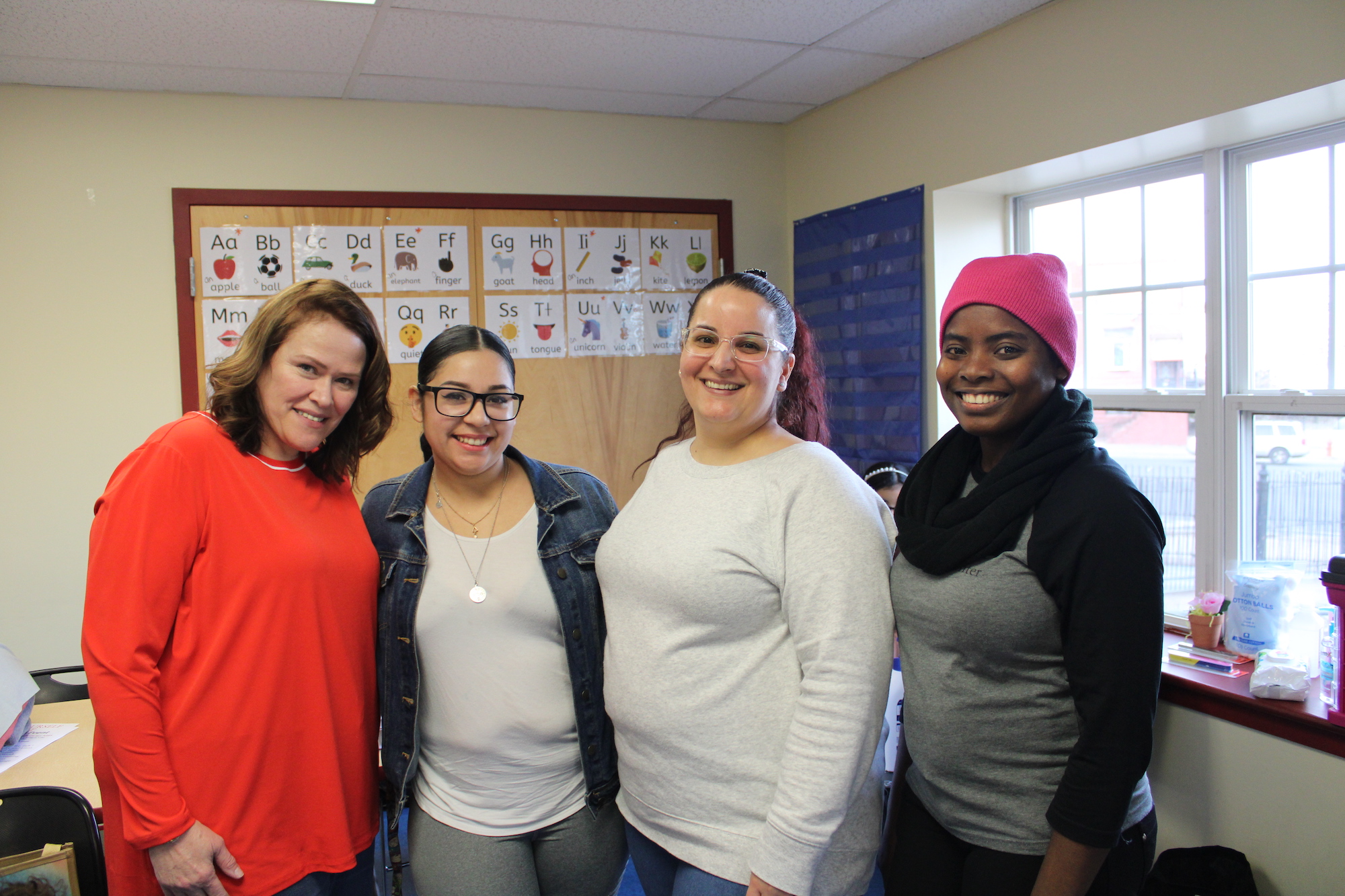 Members of Team Latina, including Dr. Linda Maldonado, Glenda Vargas, Leslie Gonzalez, and Nahomie Laurore, project director at the Thea Bowman's Women Center, pose for a photo on Feb. 15 at the Team Latina gathering at Community Center at Visitation in Kensington. Photo: Emily Neil / AL DÍA News.