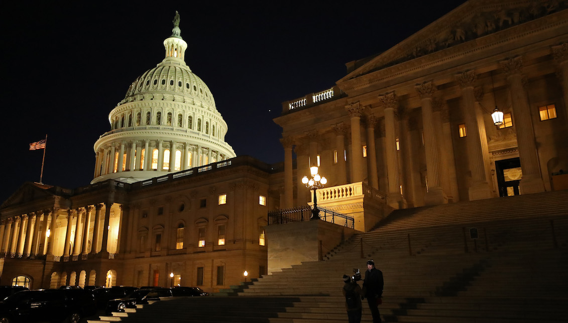 WASHINGTON, DC - JANUARY 21: A reporter and camera operator work on the Senate steps during the first evening of President Donald Trump's impeachment trial January 21, 2020 in Washington, DC. (Photo by Chip Somodevilla/Getty Images)