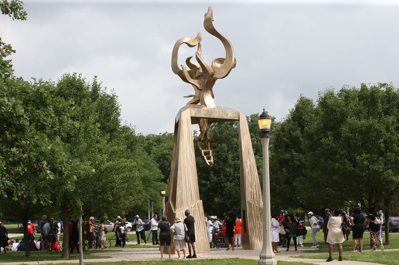 Crowds gather to view The Light of Truth monument in honor of journalist and activist Ida B. Wells in Chicago's Bronzeville neighborhood on June 30, 2021. Photo Credit: Antonio Perez / Chicago Tribune.