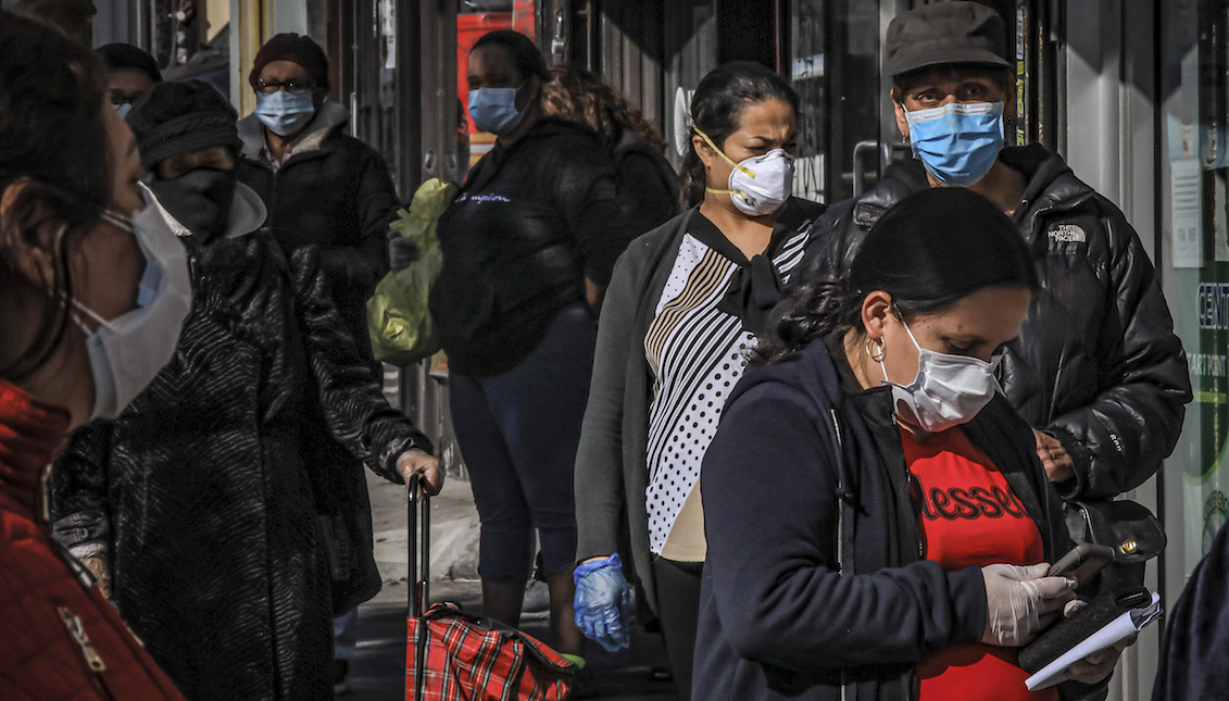 Residents of Brooklyn's Sunset Park wear masks while waiting in line to enter a store in New York on May 5, 2020. Bebeto Matthews/AP