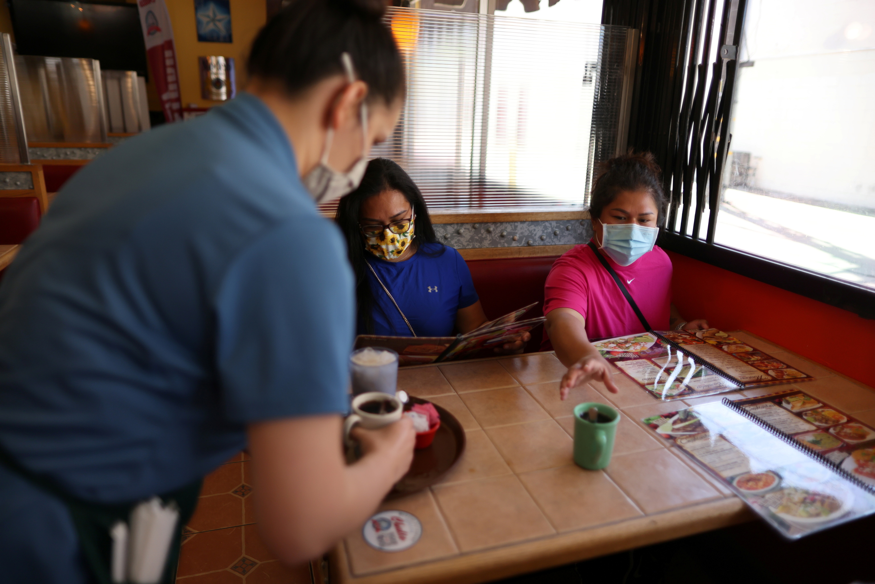 Customers wearing the mask inside a restaurant in Los Angeles.