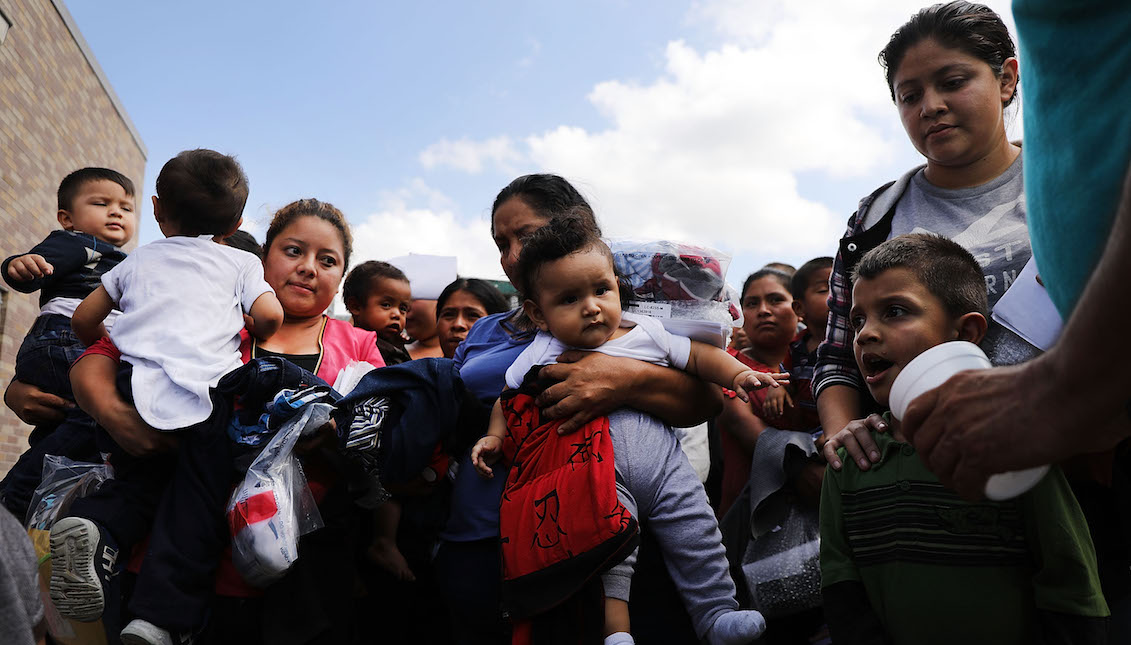 MCALLEN, TX - JUNE 22: Dozens of women and their children, many fleeing poverty and violence in Honduras, Guatemala, and El Salvador, arrive at a bus station following release from Customs and Border Protection on June 22, 2018, in McAllen, Texas. (Photo by Spencer Platt/Getty Images)