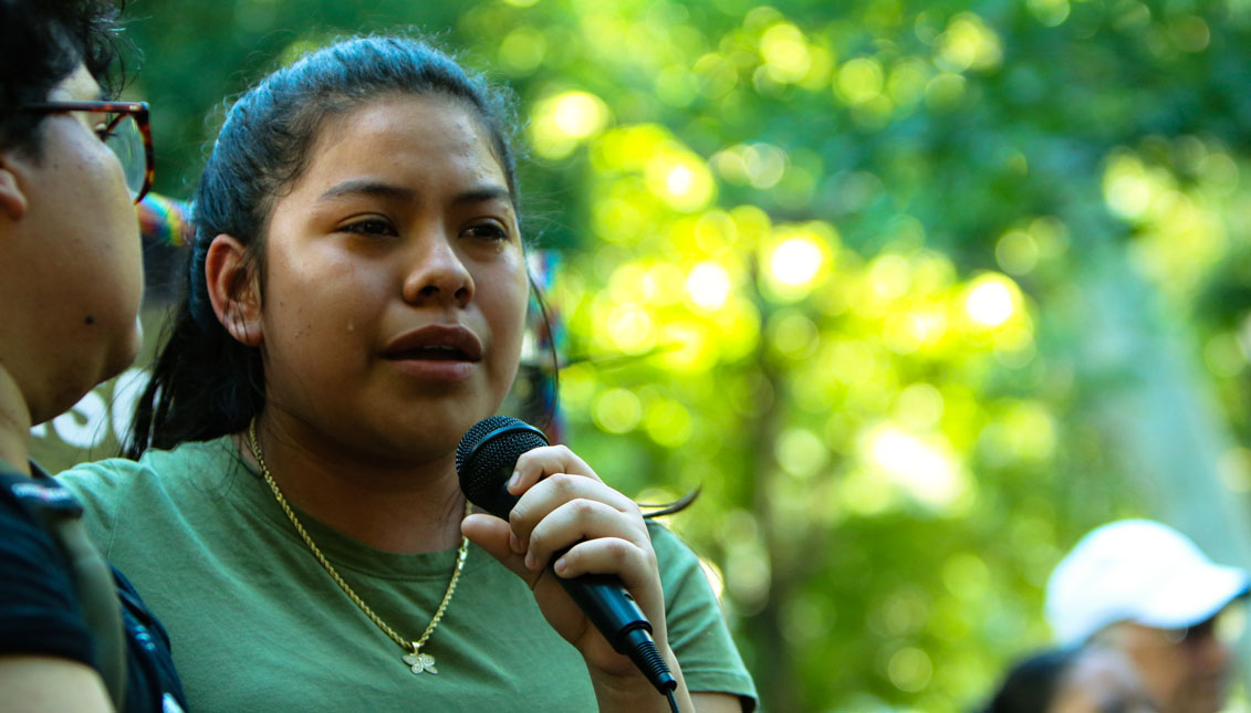 Keyri Artillero Apolonio cries while speaking at the protest about her family’s experience seeking asylum at the U.S.-Mexico border in 2015. Her brother was detained with adult men as a minor. Greta Anderson / AL DÍA News
