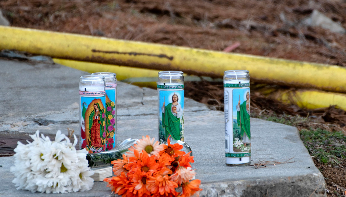 Candles and flowers left along Centennial Drive near Foundation Food Group on Friday Jan. 29. Photo: Scott Rogers/AP News