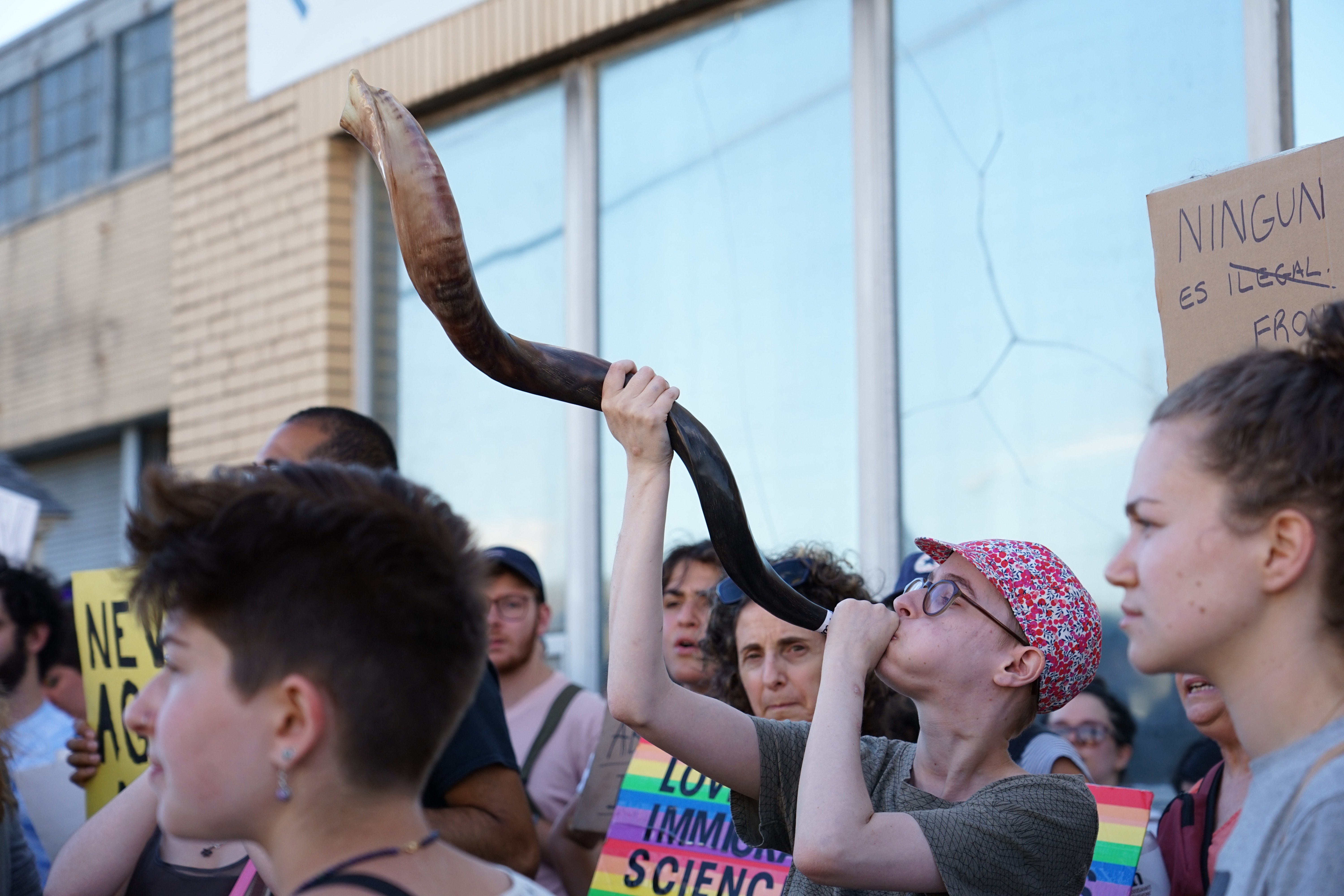 A protester blows the shofar, a ram's horn, at the demonstration outside of an ICE detention center in Elizabeth, NJ, on June 30. More than 200 Jewish activists and allies gathered to demand an end to ICE and the closure of immigrant detention centers throughout the United States. Photo: Nur Shlaopbersky