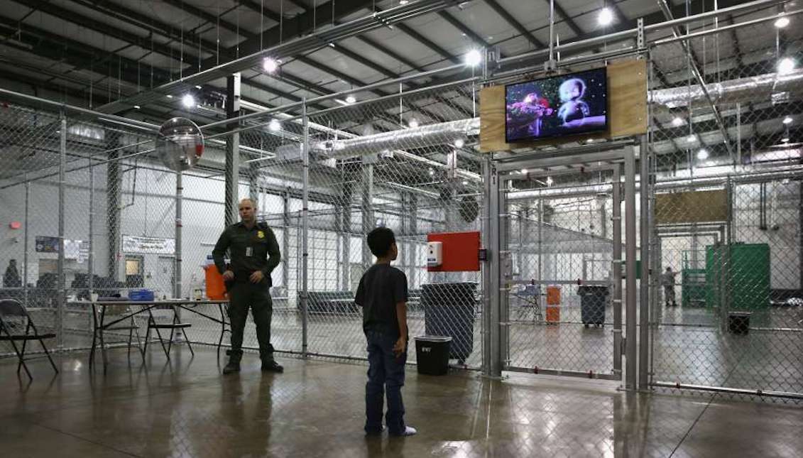 A boy from Honduras watches a movie at a detention facility run by the U.S. Border Patrol on September 8, 2014 in McAllen, Texas.