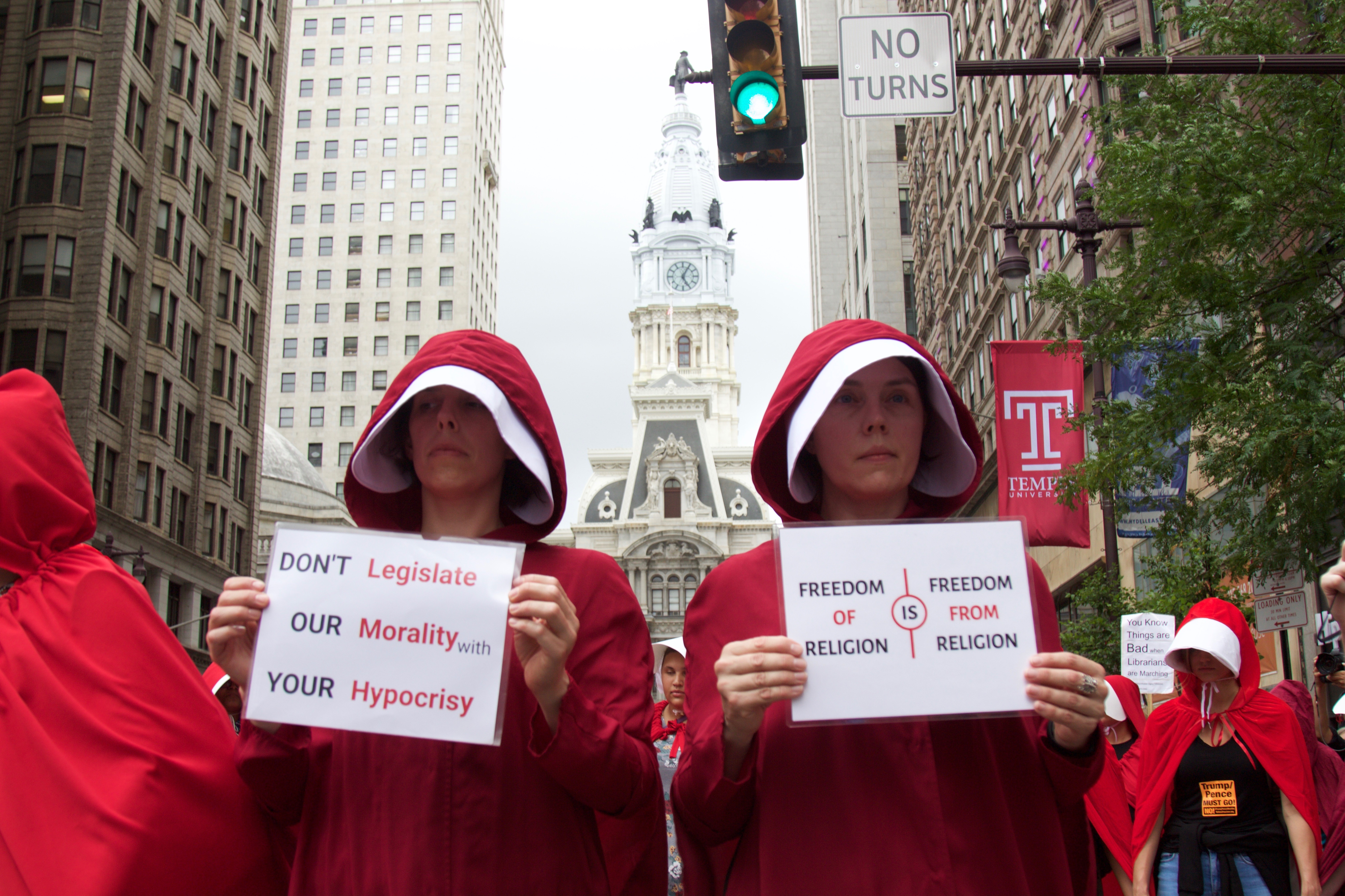 Protesters wearing costumes evoking the dystopian world of the popular Hulu series and novel, The Handmaid's Tale, stood outside the Union League in Philadelphia where Vice President Mike Pence was speaking on July 23.  Photo: Emily Neil / AL DÍA News
