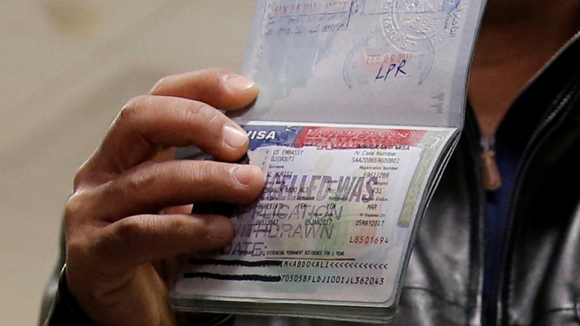 A Yemeni national, who was denied entry into the US in February, 2017 because of a country-based travel ban, shows the cancelled visa in their passport. Credit: Jonathan Ernst/Reuters