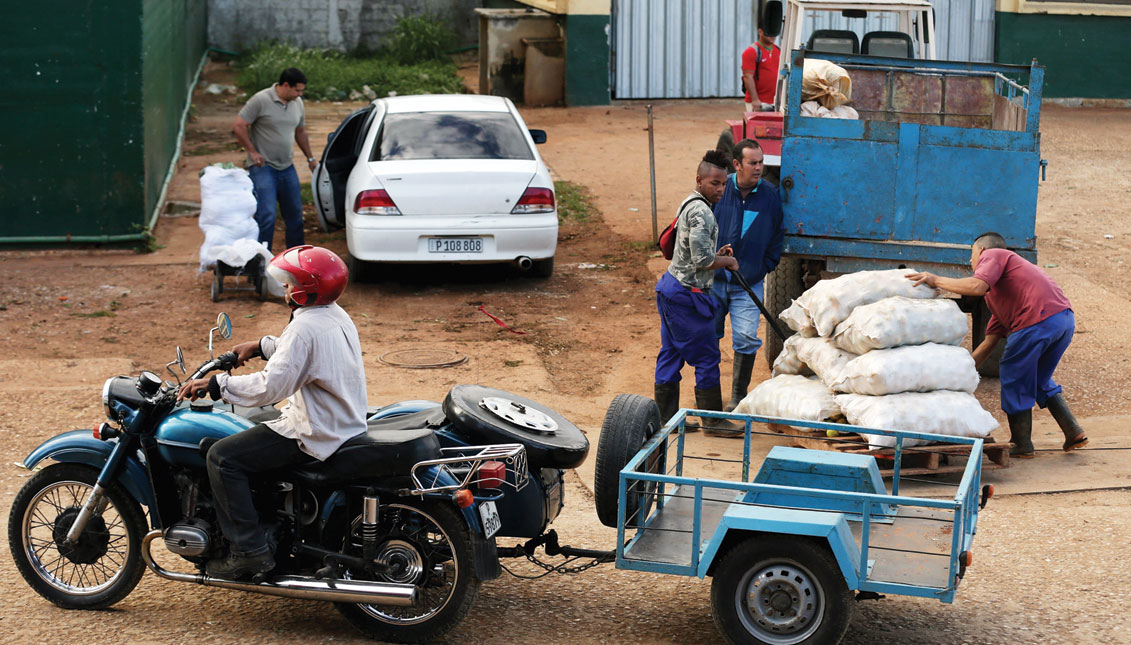 Motorcycles with side cars and trailers are used to haul goods away from the Trigal Market, a wholesale marketplace on the outskirts of the Havana, Cuba. Photo: Chip Somodevilla / Getty Images
