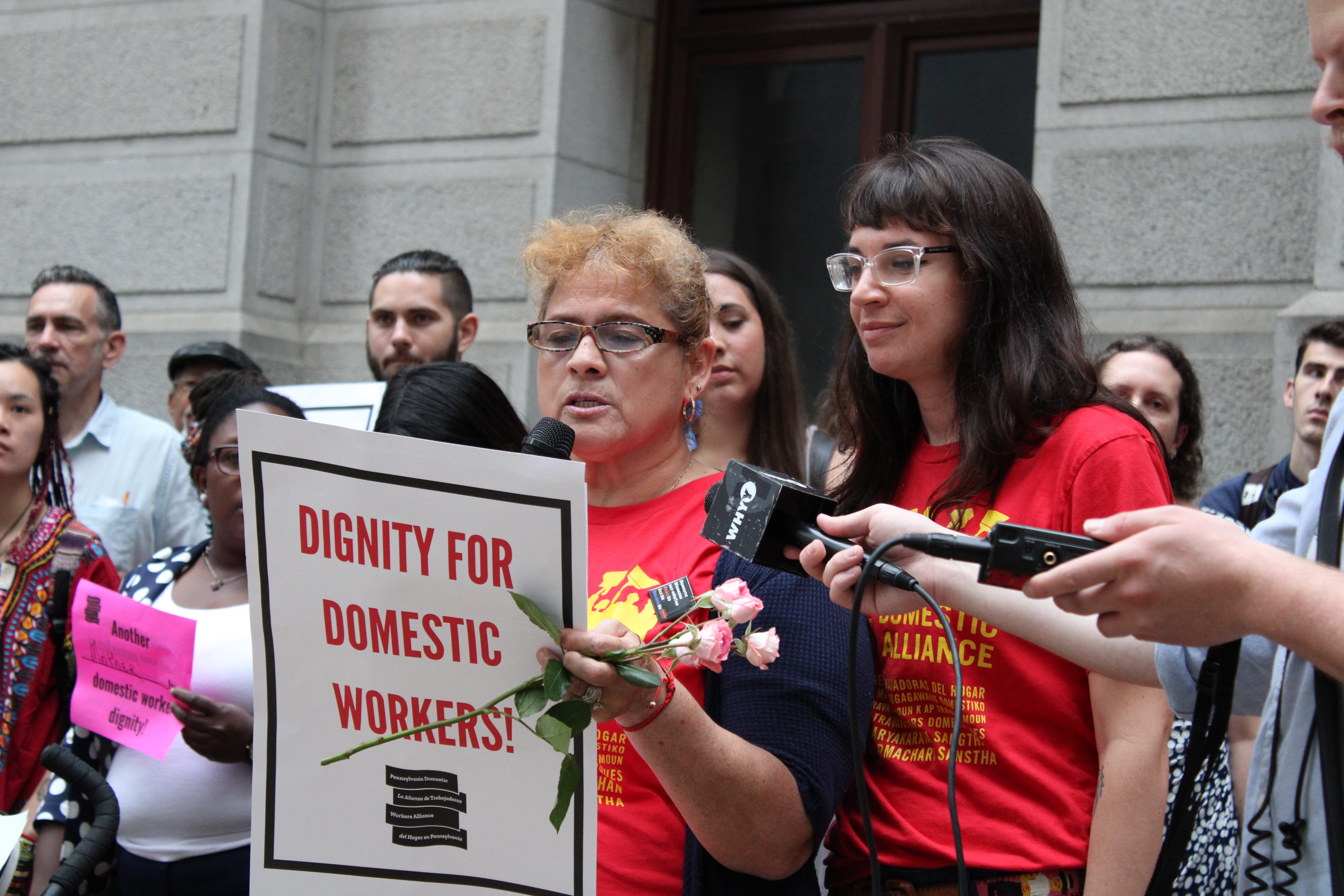 María del Carmen Díaz (left), a domestic worker and leader in the Pennsylvania Domestic Workers Alliance, speaks on June 20 about the legislation introduced to City Council which extends a range of labor rights and protections to housekeepers, nannies, caretakers, and others in the domestic worker industry. Nicole Kligerman (right), director of the PDWA, stands by, providing translation from Spanish to English. Photo: Emily Neil / AL DÍA News