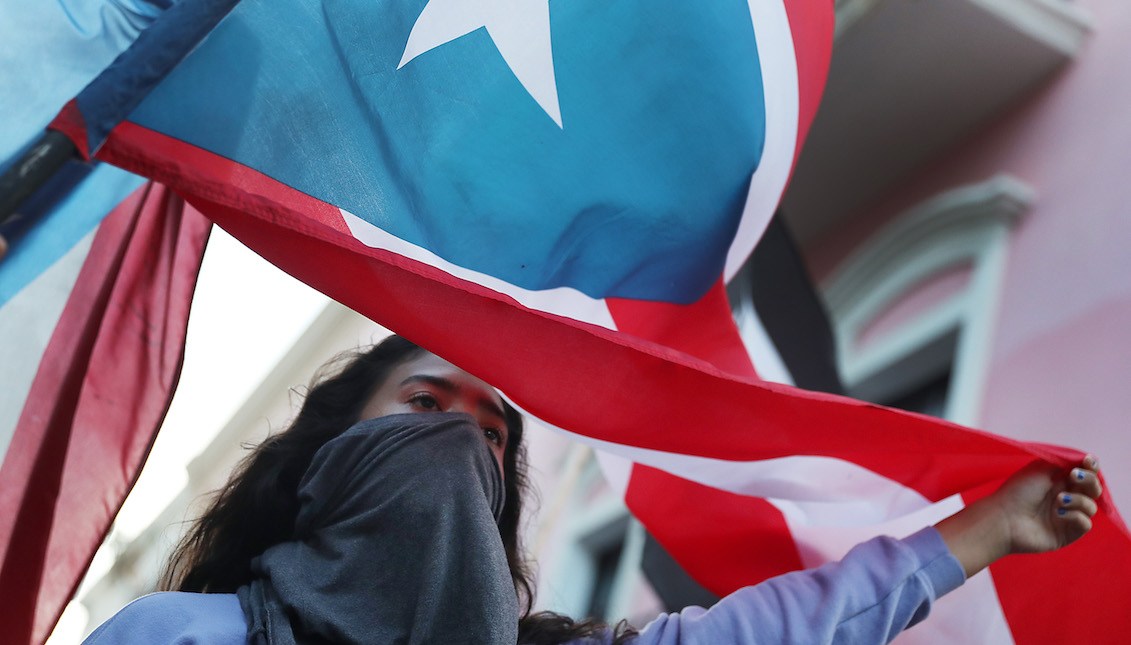 SAN JUAN, PUERTO RICO - AUGUST 02: People celebrate together after the 5pm hour which was when Ricardo Rossello, the Governor of Puerto Rico, agreed to step down from power on August 2, 2019 in Old San Juan, Puerto Rico. (Photo by Joe Raedle/Getty Images)