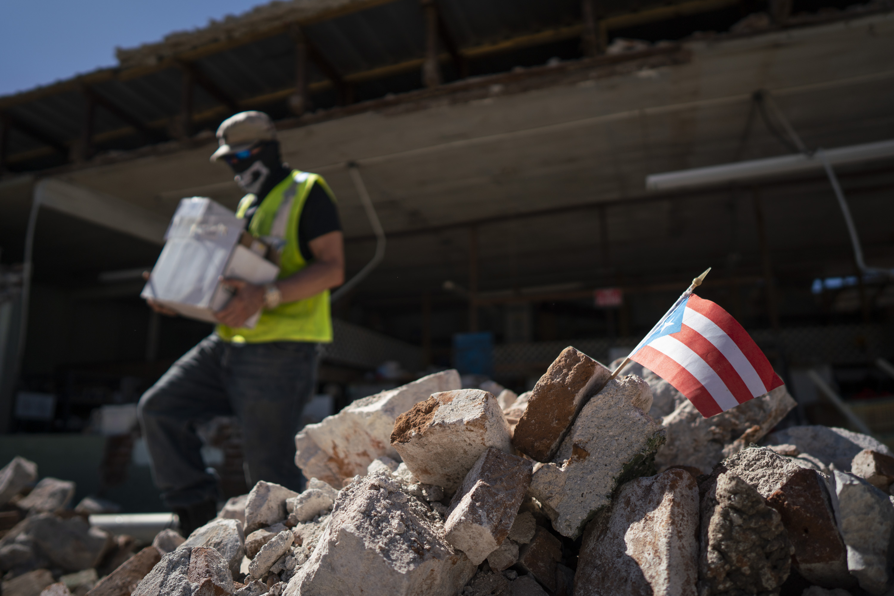 GUANICA, PUERTO RICO - JANUARY 7: A Puerto Rican flag sits in a pile of rubble after a 6.4 earthquake hit just south of the island on January 7, 2020 in Guánica, Puerto Rico. This morning's earthquake was preceded by a series of smaller quakes in the south of the island with the epicenter in Guánica. (Photo by Eric Rojas/Getty Images)