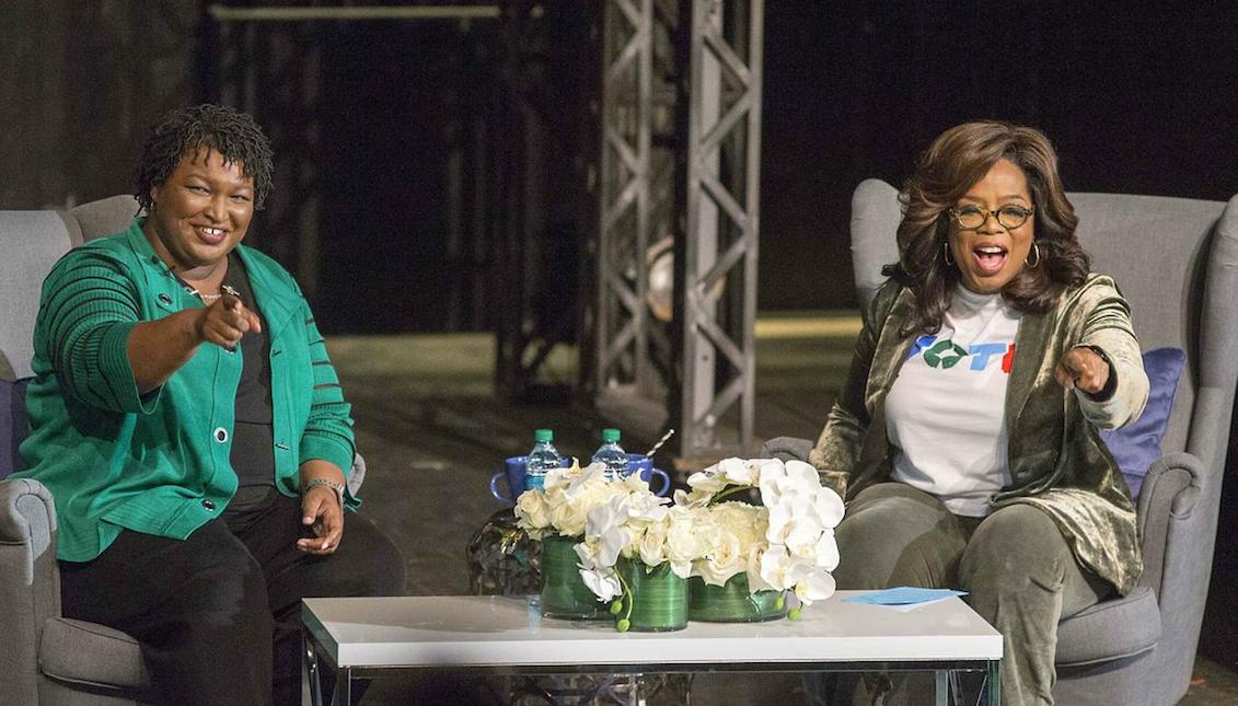 Oprah Winfrey, right, and Georgia Gov. Stacey Abrams, greet a crowd gathered for a town hall conversation at the Jennie T. Anderson Theater of the Cobb Civic Center in Marietta, Ga., On Thursday, November 1 of 2018. (Alyssa Pointer/Atlanta Journal-Constitution)