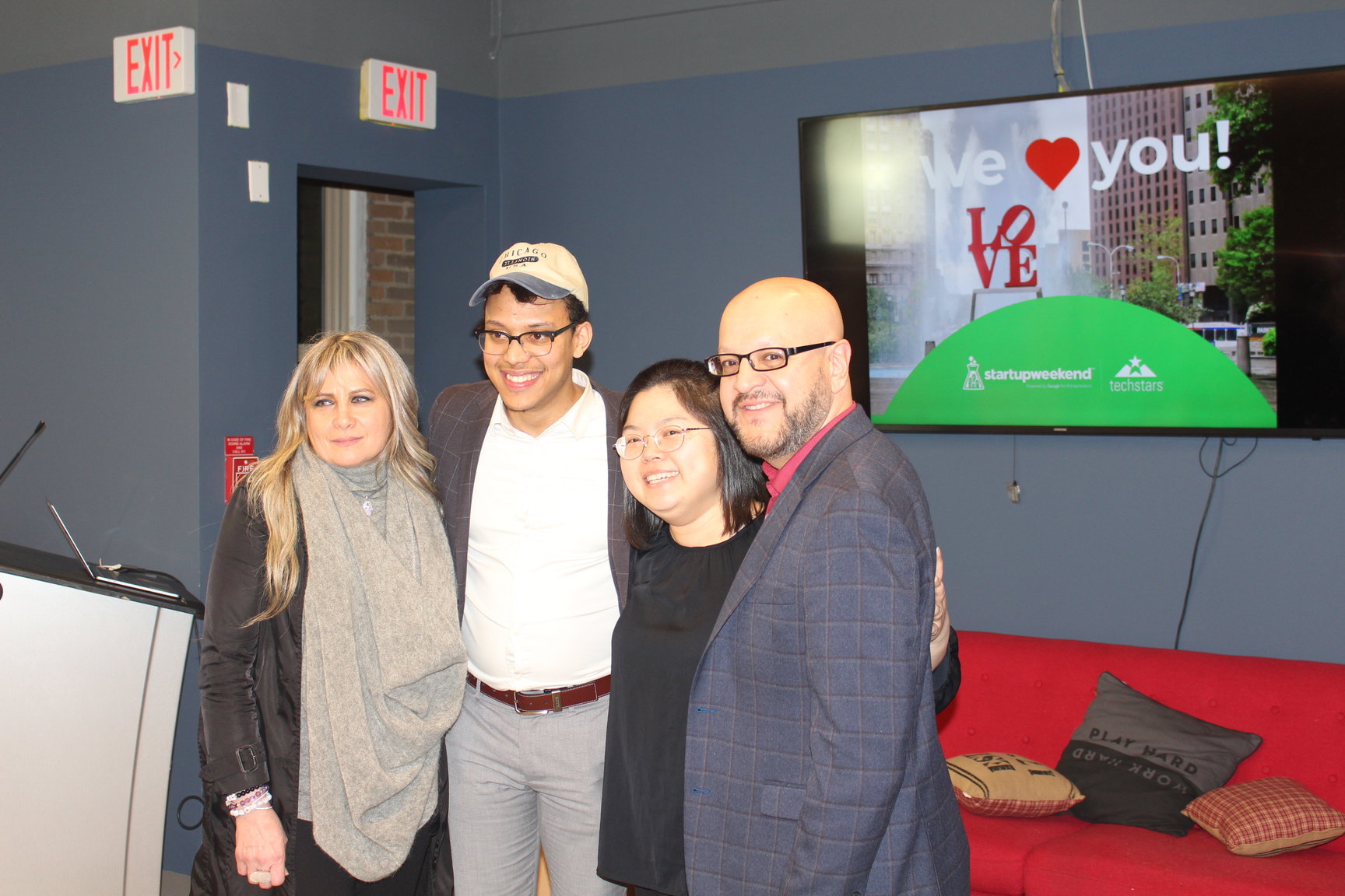 Members of the first-place team Dawn Ferrezza (far left) and Judy Chu (second from right) pose with event mentor Juan Gabriel (second from left) and event judge Javier Suarez (far right) during the final day of the Startup Weekend in Philly on Jan. 26. Photo: Jensen Toussaint/AL DÍA News. 