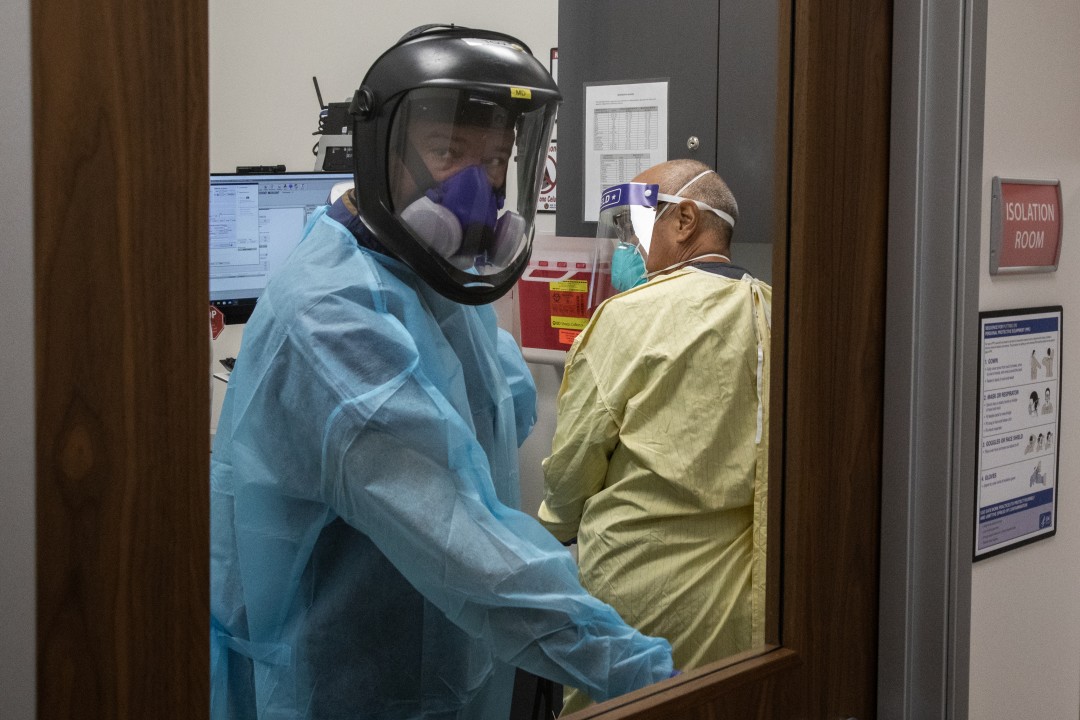 Dr. Juan Manuel Tovar in an isolation room to care for a sick patient. San Ysidro Health Chula Vista Urgent Care. Jarrod Valliere / The San Diego Union-Tribune.