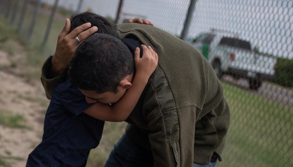 Stock Photo: A four-year-old child cries in the arms of a family member while border patrol agents apprehended him and others after illegally crossing the Mexican border near McAllen, Texas, U.S., May 2, 2018. REUTERS/Adrees Latif.