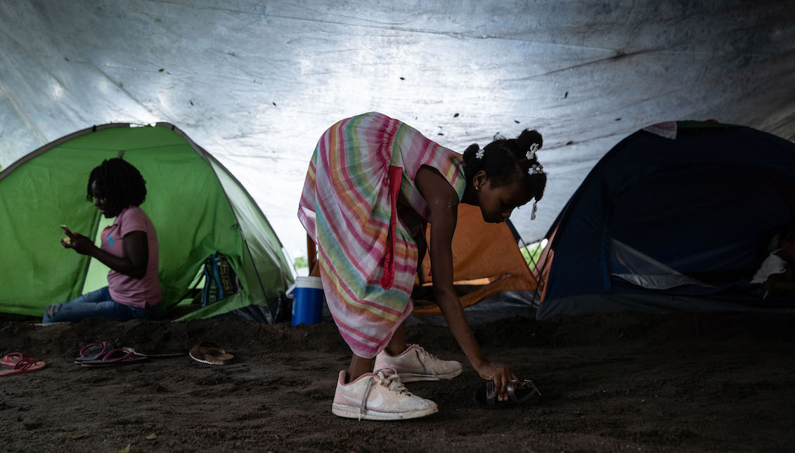 TAPACHULA, MEXICO - JUNE 18: A young girl plays next to a tent where she is temporarily living on June 18, 2019 in Tapachula, Mexico. The Mexican government launched a deployment of the National Guard seeking to control the flux of migrants crossing from Guatemala to Mexico, as part of an agreement with the US government to avoid tariffs on all Mexican exports. (Photo by Toya Sarno Jordan/Getty Images)