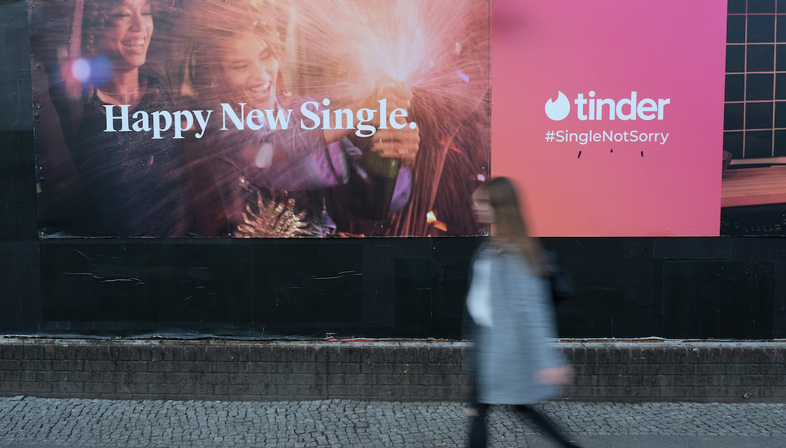 BERLIN, GERMANY - FEBRUARY 18: A young woman walks past a billboard advertisement for the dating app Tinder on February 18, 2019, in Berlin, Germany. Tinder has emerged as one of the most popular dating apps. (Photo by Sean Gallup/Getty Images)