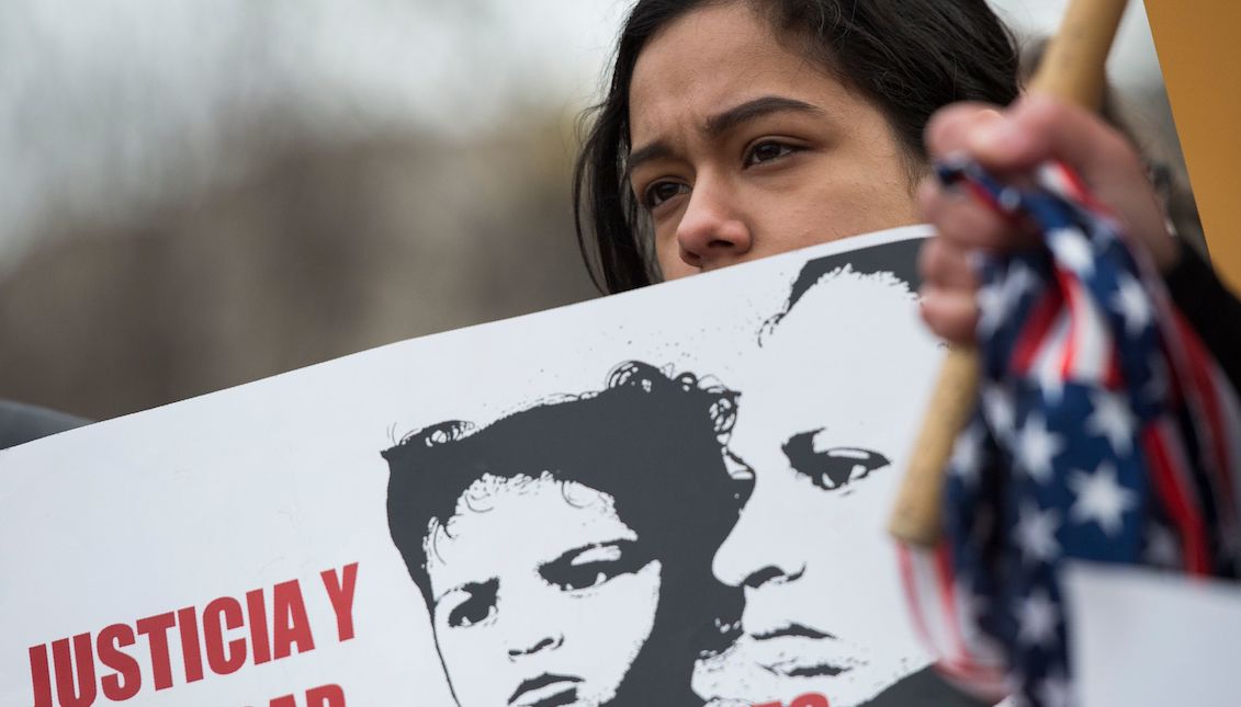 A young girl looks on as other immigrants and activists protest near the White House to demand that the Department of Homeland Security extend Temporary Protected Status (TPS) for more than 195,000 Salvadorans on January 8, 2018, in Washington, D.C. Andrew Caballero-Reynolds/AFP/Getty Images.