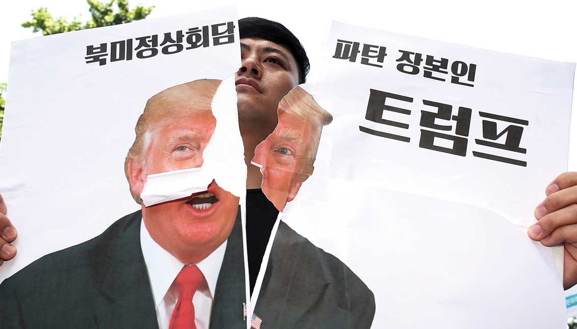 A protester breaks a poster with the photograph of President Donald J. Trump, who canceled the summit he was to hold on June 12 with the North Korean leader, Kim Jong-un, although he opened the door to reprogramming it and threatened Korea North with a military response if it acts "recklessly". EFE