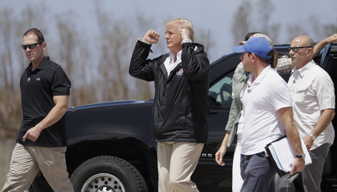 President Donald Trump gestures after arriving at Luis Muñez Air National Guard Base in San Juan, Puerto Rico, on Tuesday, October 3, 2017 after Hurricane Maria. (AP Photo/Evan Vucci)