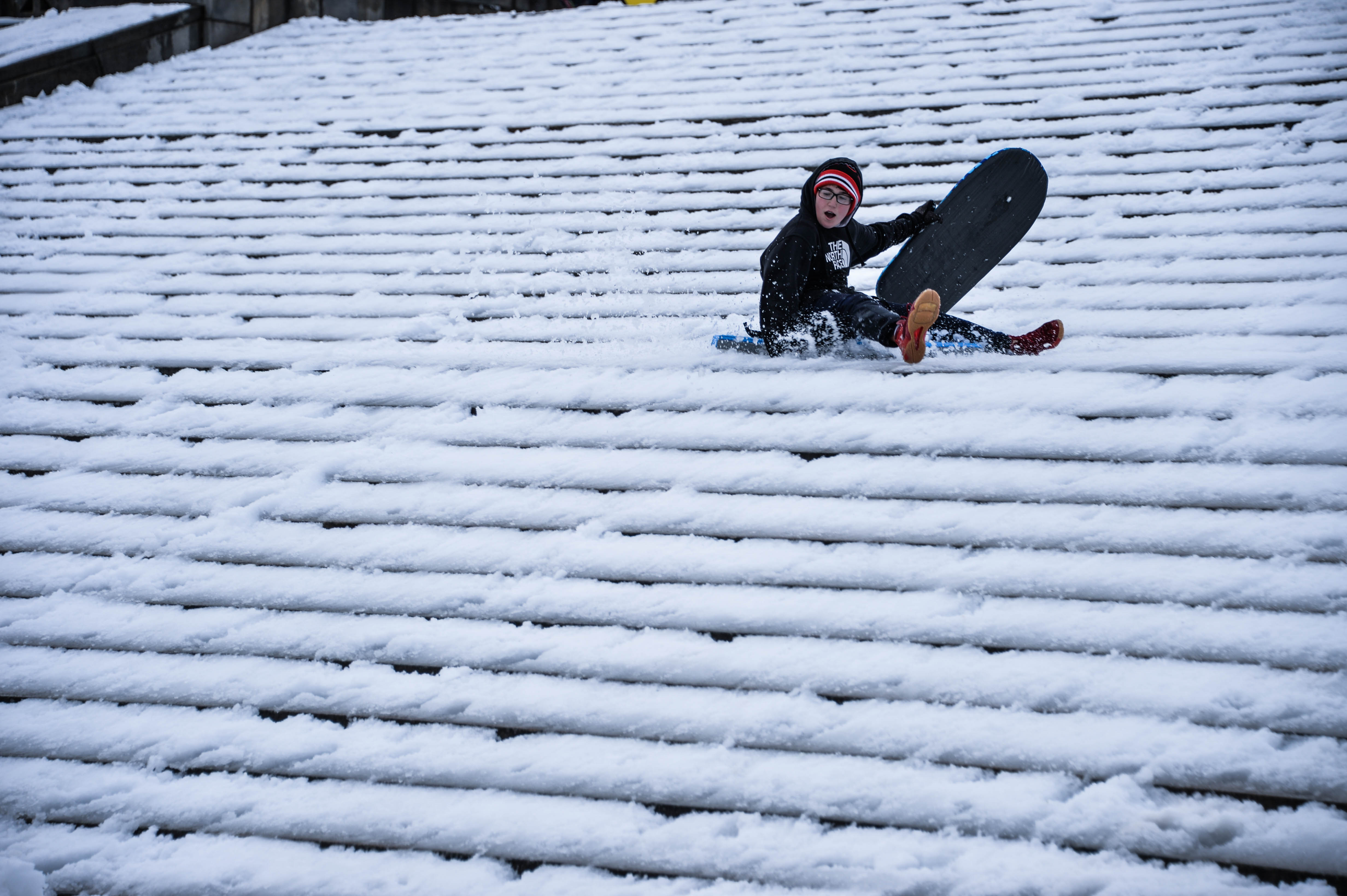 Kids and adults grab their sleds or snowboards and race down the steps of the Art Museum.  Photo: Peter Fitzpatrick/ AL DIA News
