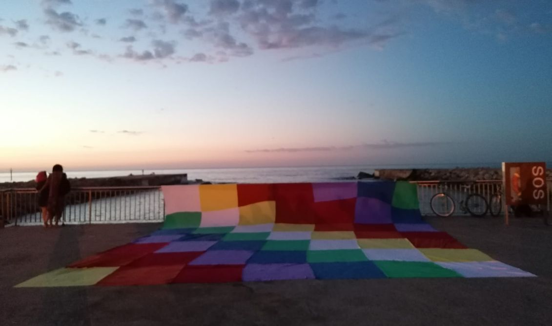 Celebration of Inti Raymi. Whipala flag on the beach of Somorrostro in Barcelona.