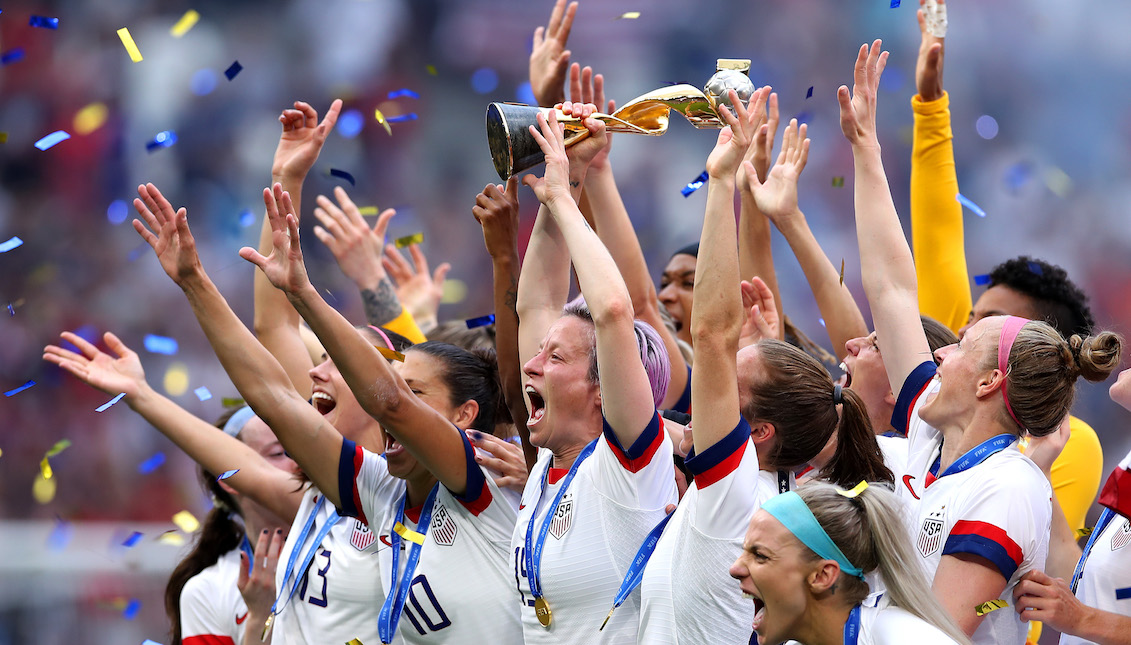 LYON, FRANCE - JULY 07: Megan Rapinoe of the USA lifts the FIFA Women's World Cup Trophy following her team's victory in the 2019 FIFA Women's World Cup France Final match between The United States of America and The Netherlands at Stade de Lyon on July 07, 2019 in Lyon, France. (Photo by Alex Grimm/Getty Images)