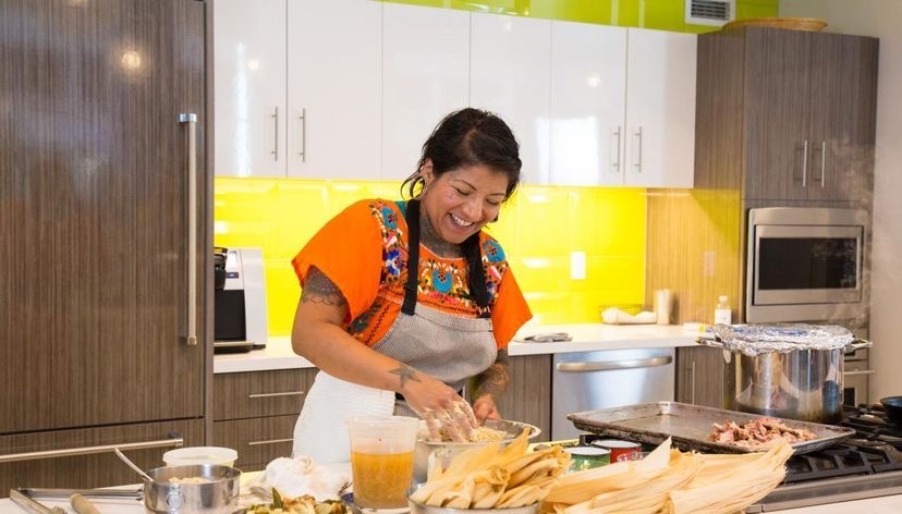 Jen Zavala smiles as she makes one of her dishes. Photo Courtesy of Chef in Residence. 