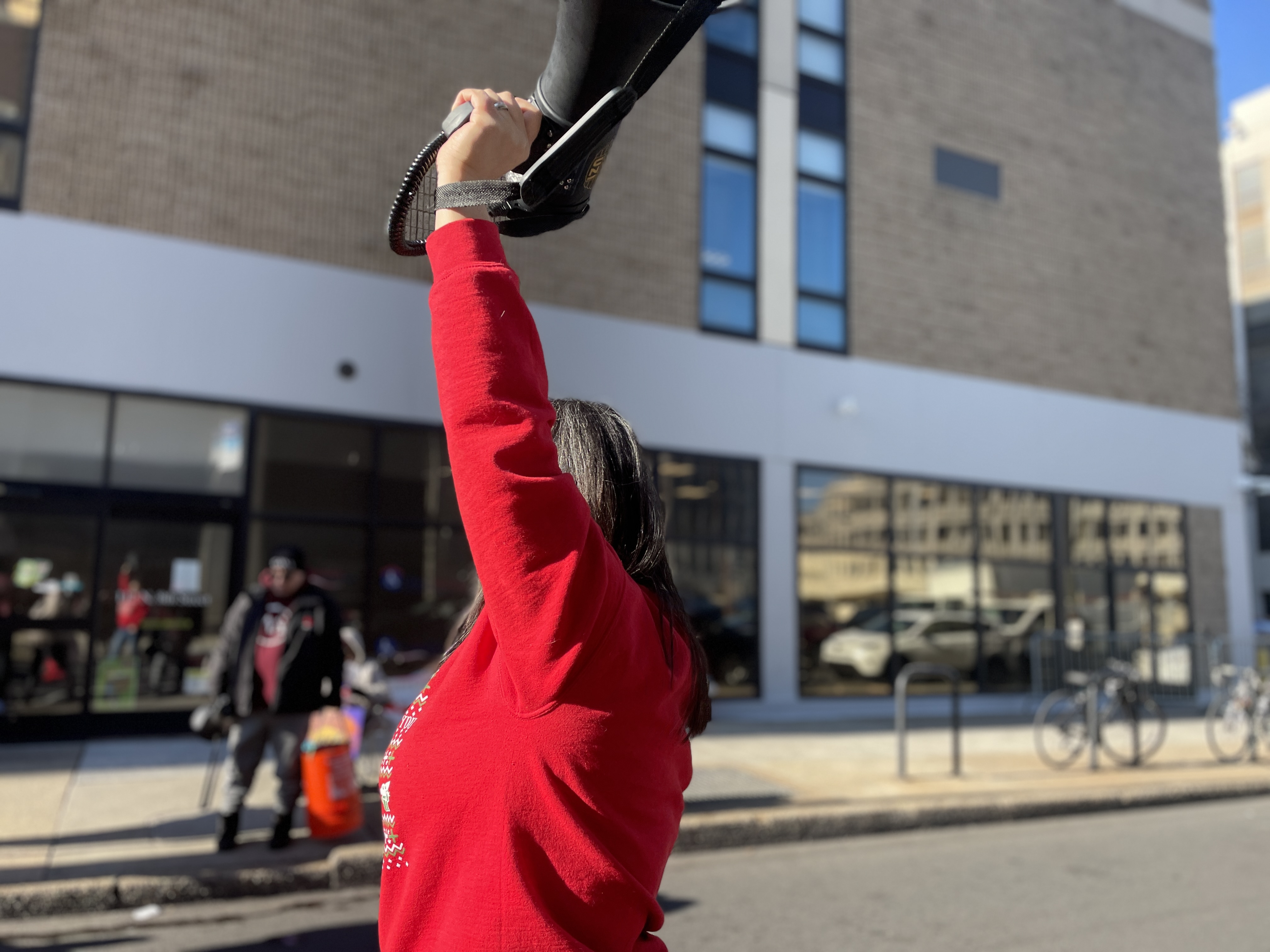 Woman leads rally in front of ICE office in Philly.