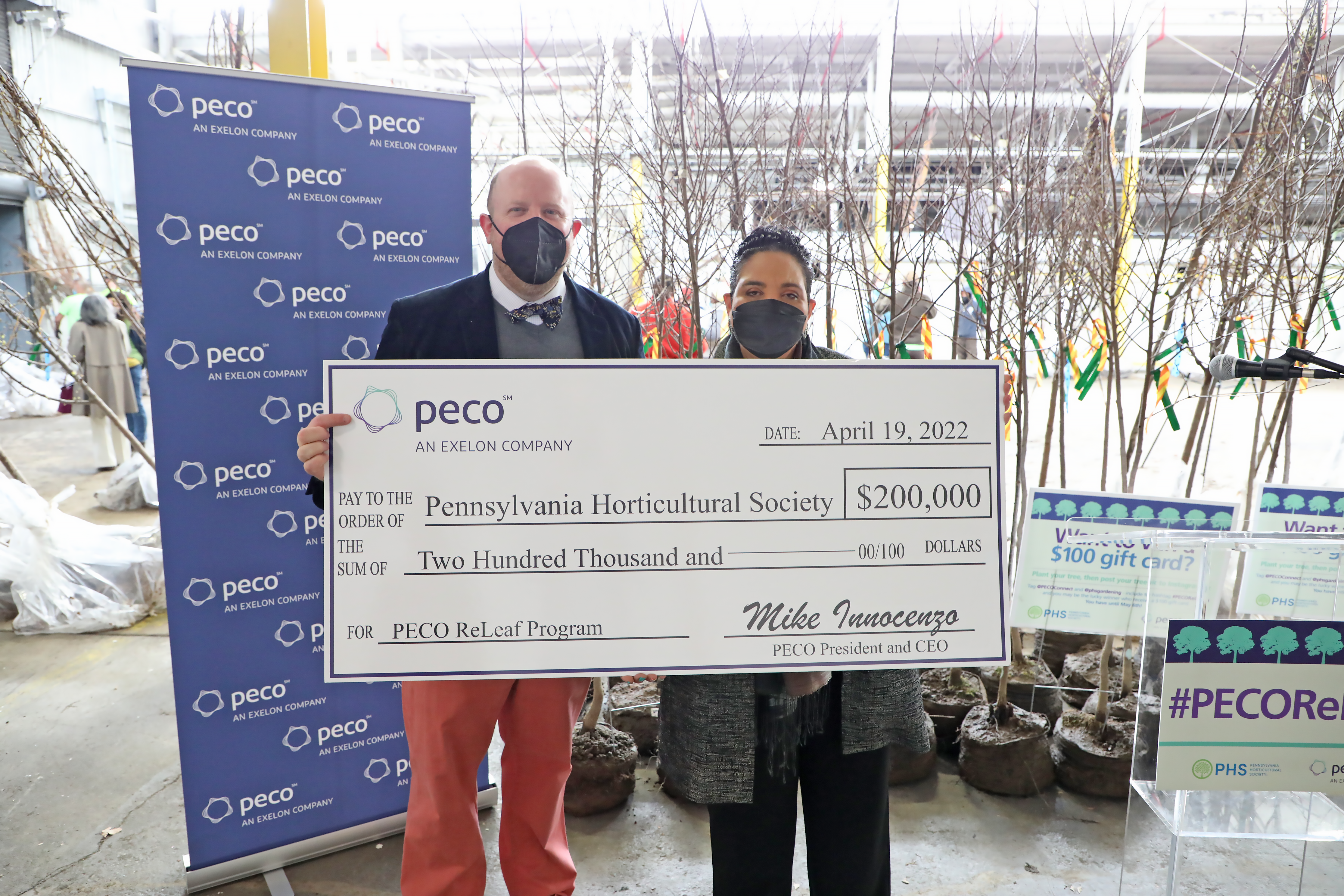 PECO’s director of corporate and community impact and PHS' president pose with $200,000 check. Photo Courtesy of PECO. 