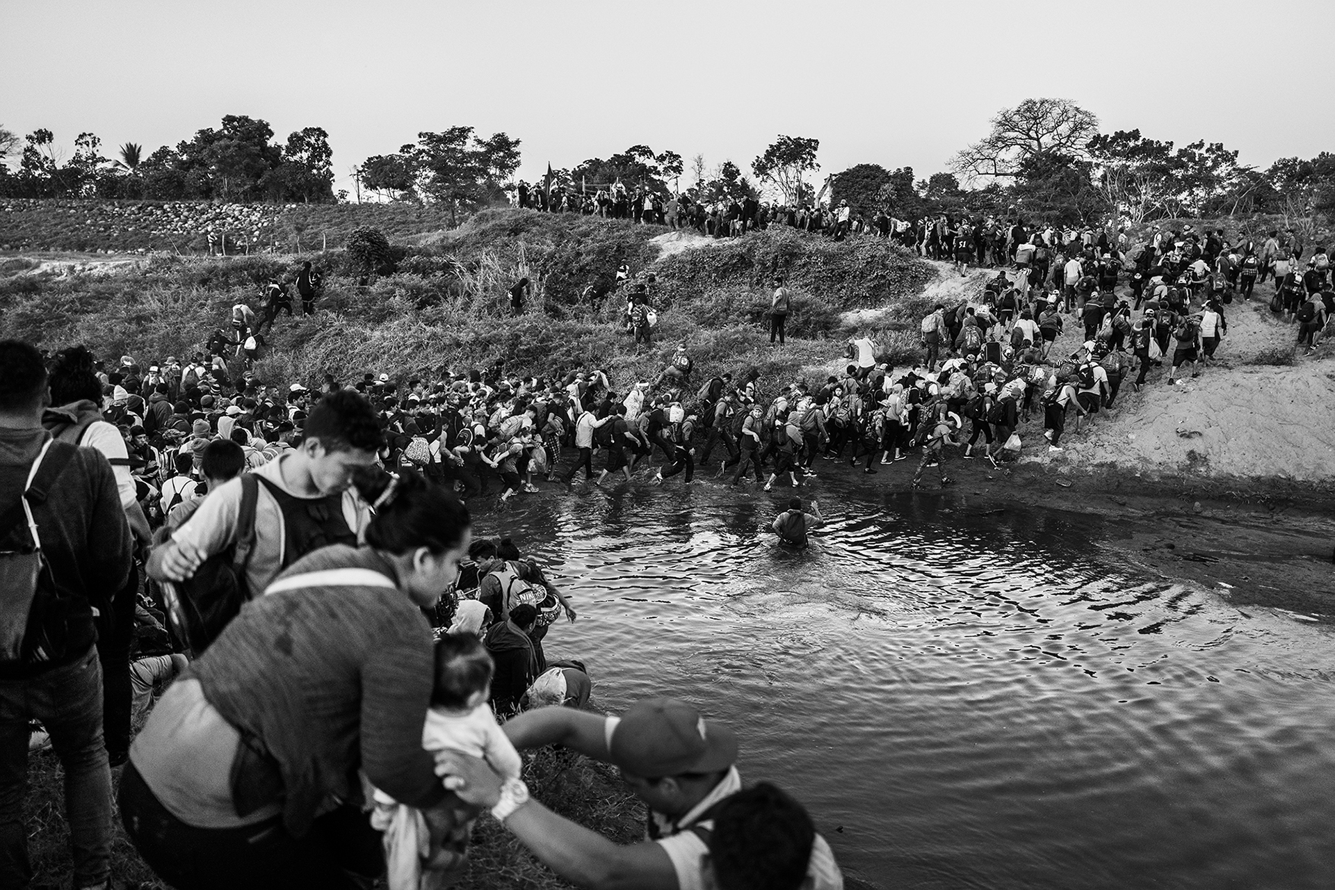 Migrant caravan crossing the river that borders Guatemala and Mexico, 2020. Photo by Pew Fellow Ada Trillo